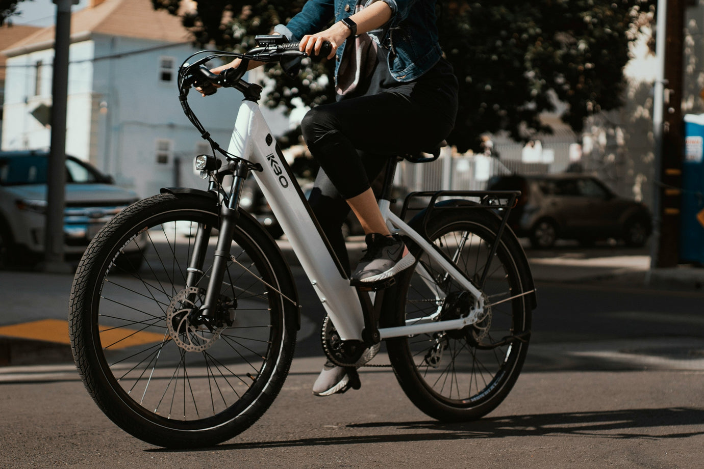 Rider on a modern KBO electric bike commuting through the city — find your perfect folding e-bike on MyNextBike.co.uk.