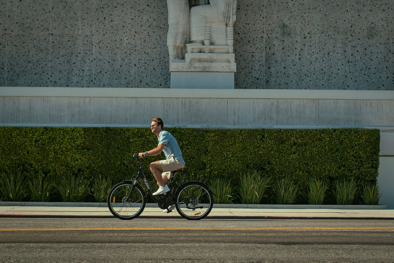 Man riding an electric road bike on a sunny city street — showcasing smooth, effortless e-bike performance for urban commuters made easy with MyNextBike.co.uk. 