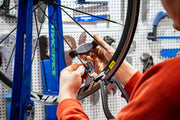 a fitness-first cyclist examining a used road bike closely before buying.