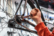 an urban commuter inspecting the frame of a used city bike to verify it before buying