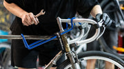 Cyclist inspecting used bicycle when deciding which second-hand bike to buy