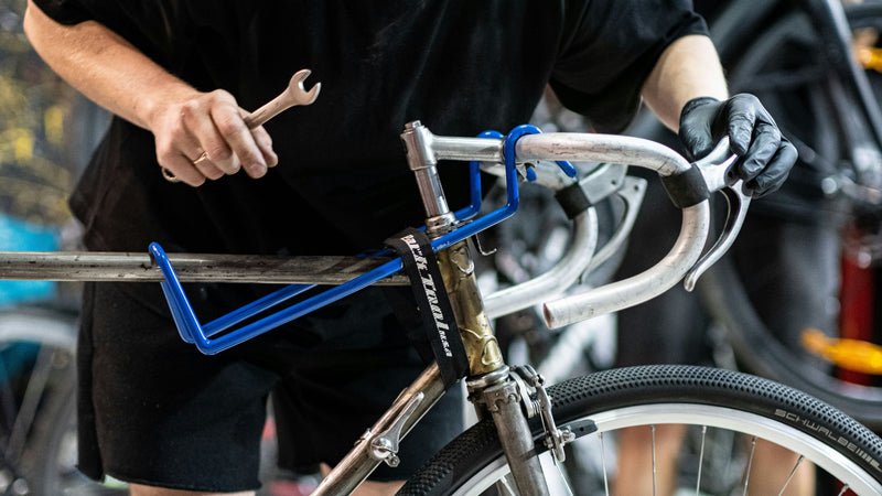 Cyclist inspecting used bicycle when deciding which second-hand bike to buy