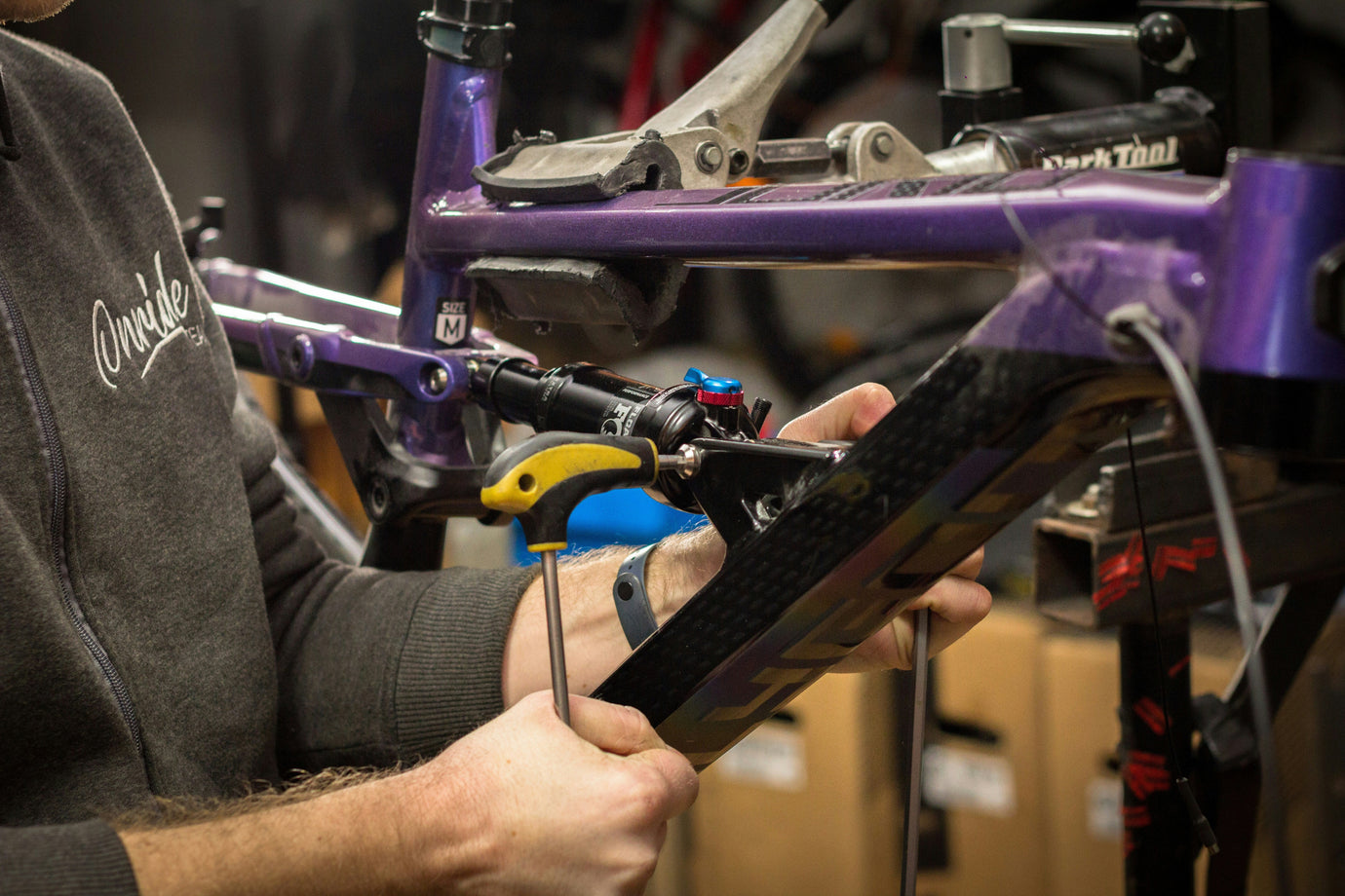 Urban commuter inspecting a used bike's frame before buying, checking for stolen bike.