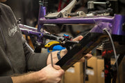 Urban commuter inspecting a used bike's frame before buying, checking for stolen bike.