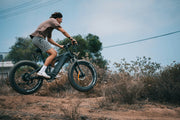 Cyclist riding an electric fat tyre bike on an off-road trail, representing outdoor adventure, e-bike lifestyle, all-terrain cycling, and modern electric bicycles