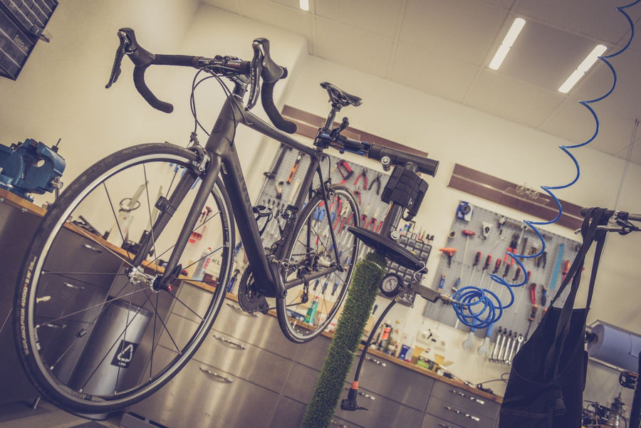 Road bike on a repair stand in a bike workshop