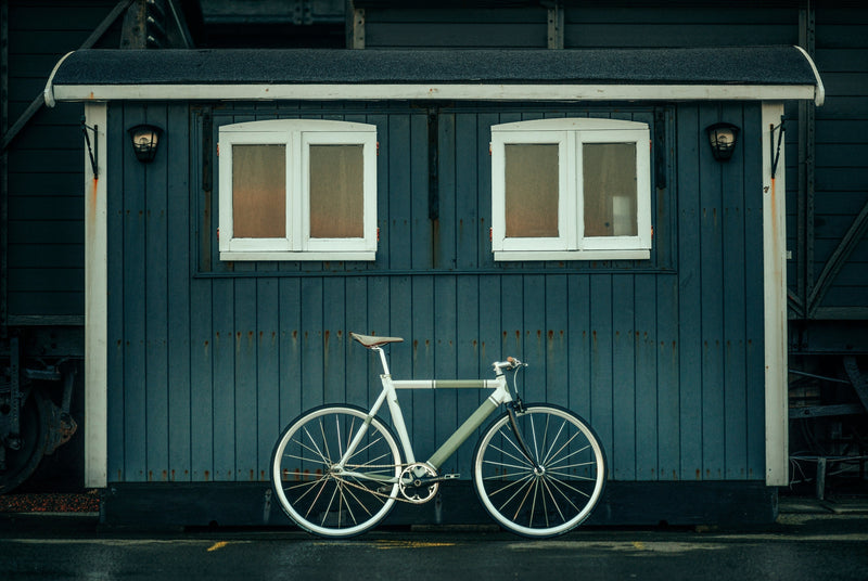 High end commuter bike in front of a shed backdrop displaying luxury road travel and safety UK