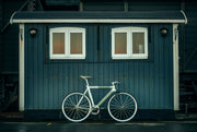 High end commuter bike in front of a shed backdrop displaying luxury road travel and safety UK